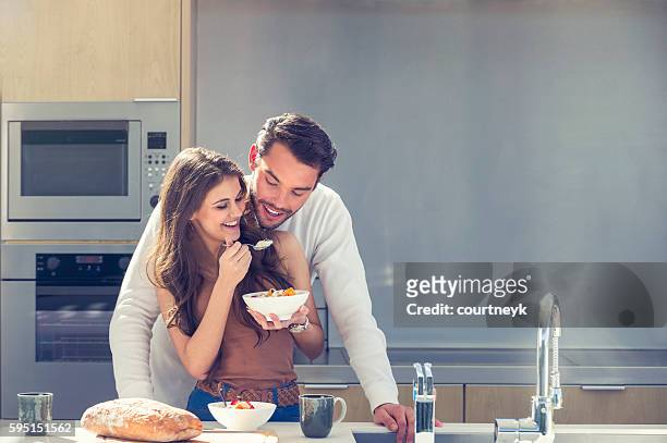couple having fun eating breakfast. - sharing coffee stock pictures, royalty-free photos & images