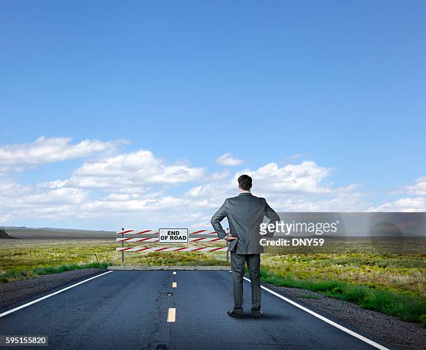 businessman standing at end of the road - capitalism stock pictures, royalty-free photos & images