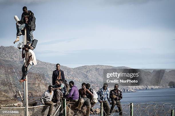 African migrants attempt to scale the fence at the border between Morocco and the North African Spanish enclave of Melilla, on April 3 in Melilla,...