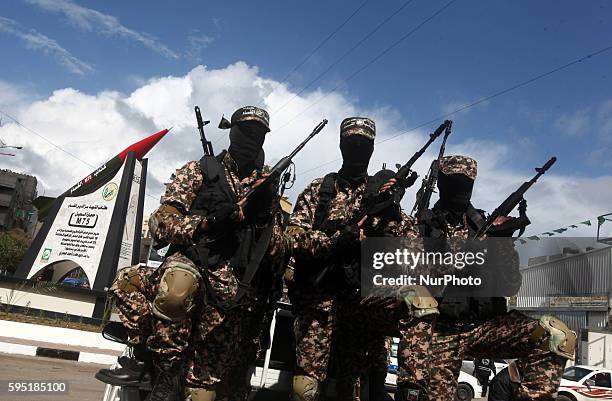 Militants in front of the monument of a homemade M75 rocket in the middle of a square in Gaza City March 10, 2014. Hamas fired M75 rockets at Tel...