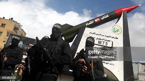 Militants in front of the monument of a homemade M75 rocket in the middle of a square in Gaza City March 10, 2014. Hamas fired M75 rockets at Tel...