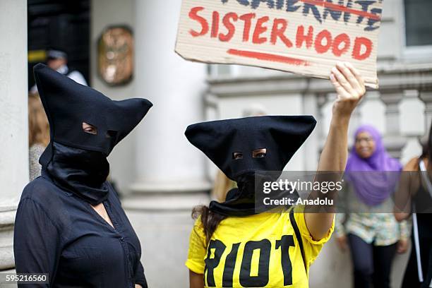 Protesters from different societies stage a demonstration named "Wear What You Want" themed as a beach party style, outside the French Embassy in...