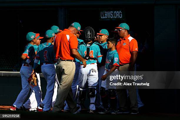 The Latin-America Team from Panama huddles at the end of an inning during the game against the Asia-Pacific Team from South Korea at Volunteer...