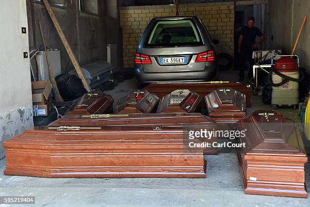Coffins are laid out on the ground on August 25, 2016 in Amatrice, Italy. The death toll in the 6.2 magnitude earthquake that struck around the...