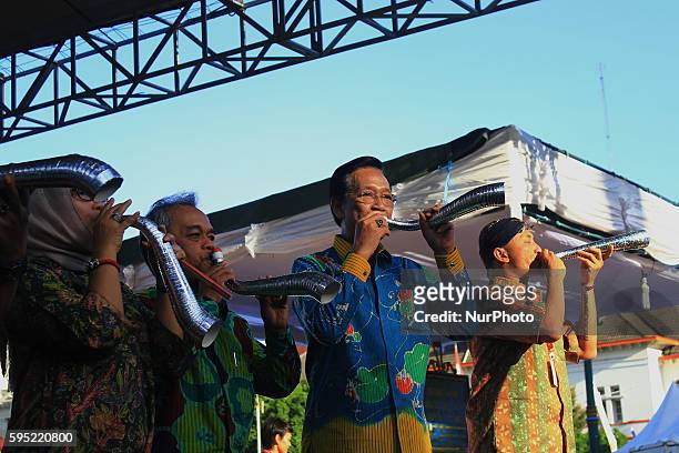 Governor of Yogyakarta province , Sri Sultan HB 10 blow the trumpet as a sign of the opening of the Yogyakarta Arts Festival in Yogyakarta, Indonesia...