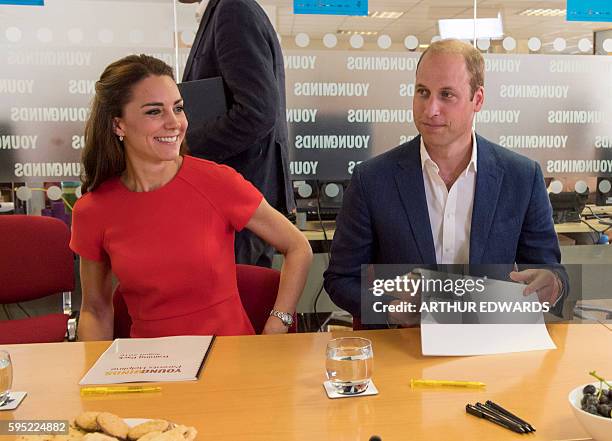 Britain's Catherine, Duchess of Cambridge and Prince William, Duke of Cambridge talk with members of staff and volunteers during a visit to a mental...