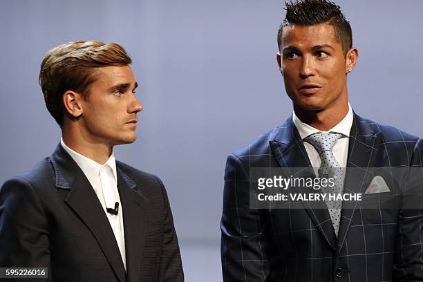 Real Madrid's Portuguese forward Cristiano Ronaldo stands next to Atletico Madrid's French forward Antoine Griezmann at the end of the UEFA Champions...