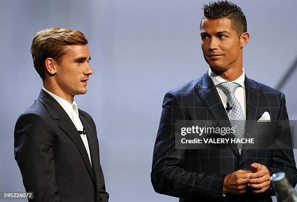 Real Madrid's Portuguese forward Cristiano Ronaldo looks at Atletico Madrid's French forward Antoine Griezmann at the end of the UEFA Champions...