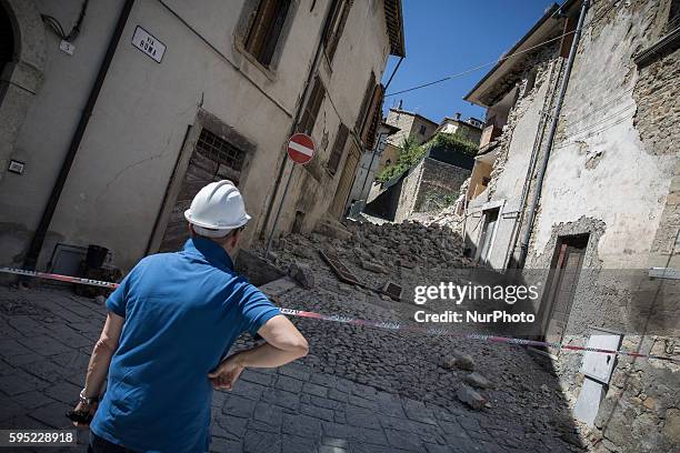 Man near a damaged building after a strong earthquake hit Accumoli on August 25, 2016. A powerful pre-dawn earthquake devastated mountain villages in...