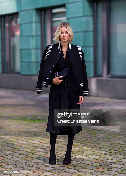 Fashion blogger Lisa Hahnbueck wearing black white Saint Laurent College Jacket, black DKNY Merino Wool Cardi Dress, black Asymmetric Slip Dress,...