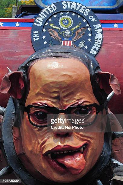 Philippines - Protesters prepare the effigy of Philippine President Benigno Aquino III as a puppy moments before the main program to welcome US...