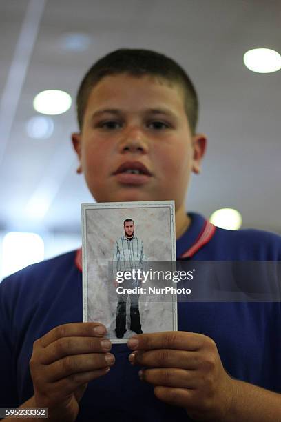 Ramallah, West Bank, Palestinian Territories, April 26, 2014: Palestinian boy hold his father photo how prisoner in Isreal prison during mass rally...