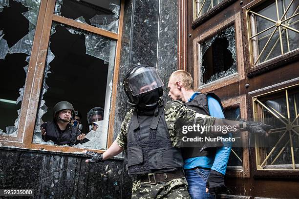 During the demostration of the first of may Pro-Russian Activist marched trought city of Donetsk. The protesters attacked building of the prosecutor....