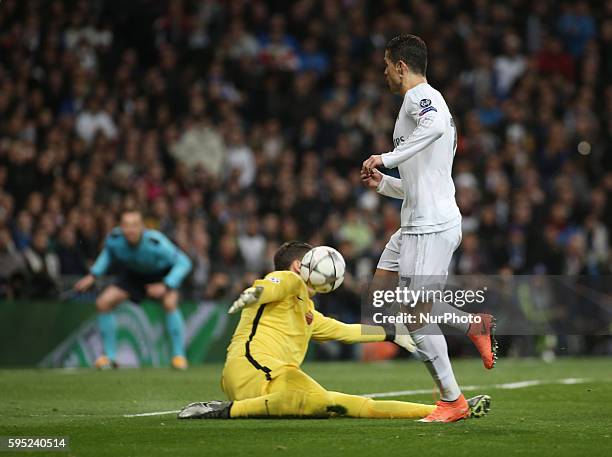 Real Madrid's Portuguese forward Cristiano Ronaldo vies with Roma's goalkeeper from Poland Wojciech Szczesny during the UEFA Champions League round...