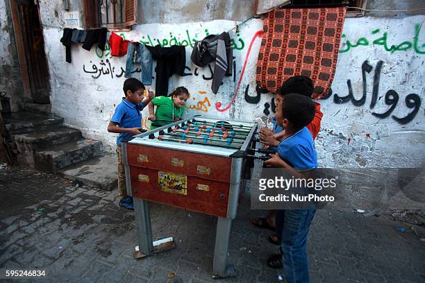 Palestinian children play at table football outside their house in the Shati refugee camp west of Gaza City, on April 27, 2014.