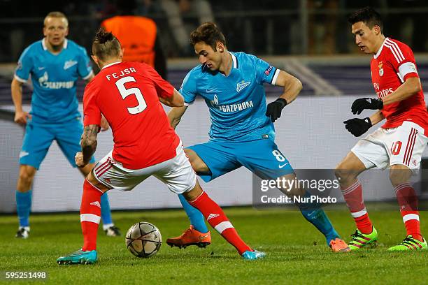 Mauricio of Zenit in action against Ljubomir Fejsa and Nicolas Gaitan of Benfica during the UEFA Champions League Round of 16 second leg match...