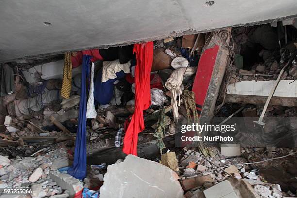 In this photograph taken on April 25 Civilians rescue an injured garment worker during a rescue operation after the eight-storey building Rana Plaza...