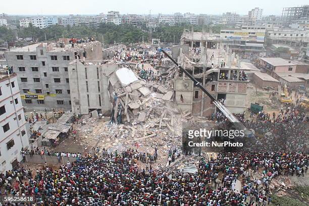In this photograph taken on April 25 Rescue workers take part in the rescue operation on the top of the damaged building at Savar Several thousand...