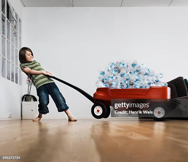 boy recycling bottles - pulling stock pictures, royalty-free photos & images