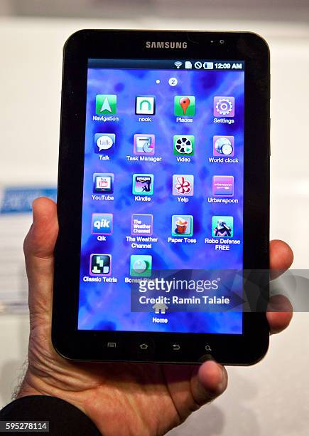 Man holds a Samsung Galaxy Tab, a 7-inch touchscreen mobile tablet, with the Android 2.2 operating system, during a news conference in New York, on...