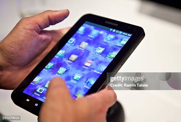 Man holds a Samsung Galaxy Tab, a 7-inch touchscreen mobile tablet, with the Android 2.2 operating system, during a news conference in New York, on...