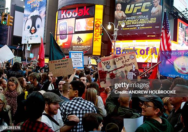 October 15, 2011 - Demonstrators taking part in the "Occupy Wall Street" protest movement gather in Times Square. The movement has spread throughout...