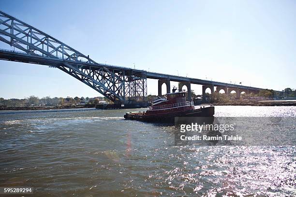 Tugboat passes under the Bayonne Bridge as it operates in New York Harbor in New York, on Tuesday October 25, 2011.