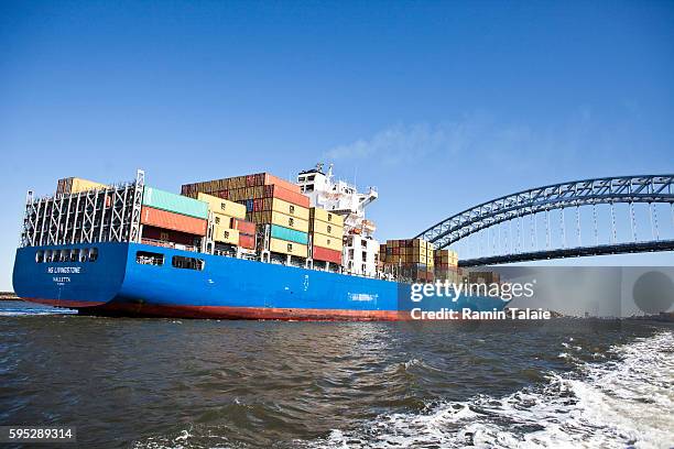 Cargo ship enters the New York Harbor passing under Bayonne Bridge in New York, on Tuesday October 25, 2011.