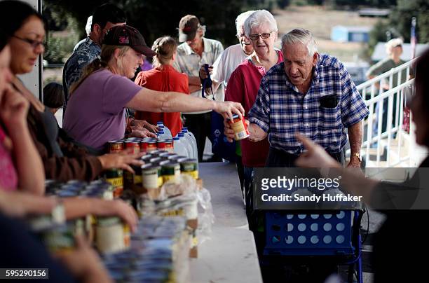 Bill Shaw,Middle, receives donated food items from volunteer Chris Lashmet at a Feeding America truck on Thursday, November 3, 2011 at the Descanso...