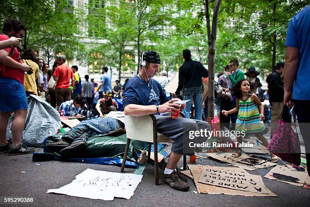 Protestor relaxes on a seat at Zuccotti Park where hundreds of demonstrators have camped out in Lower Manhattan for 14 days on Friday, September 30,...