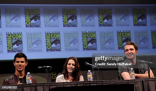 Actor's Taylor Laughtner and Kristen Stewart and Robert Pattinson speak during a panel discussion for the movie The Twilight Saga: Breaking Dawn at...