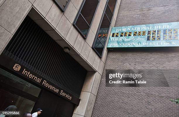 The National Debt Clock billboard is displayed next to an Internal Review Service office in midtown Manhattan on August 2, 2011 in the New York City....