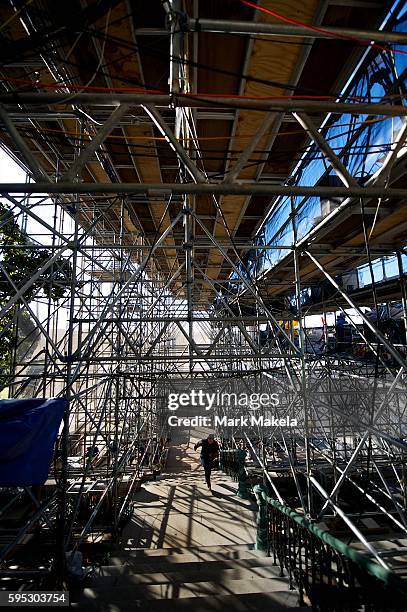 Woman races up the stairs underneath a media riser at the Capitol Building the day before President Barack Obama's 57th Inauguration in Washington...