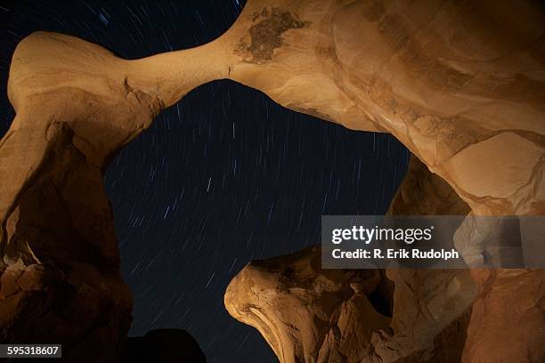 star trails in an arch - rudolph stock pictures, royalty-free photos & images