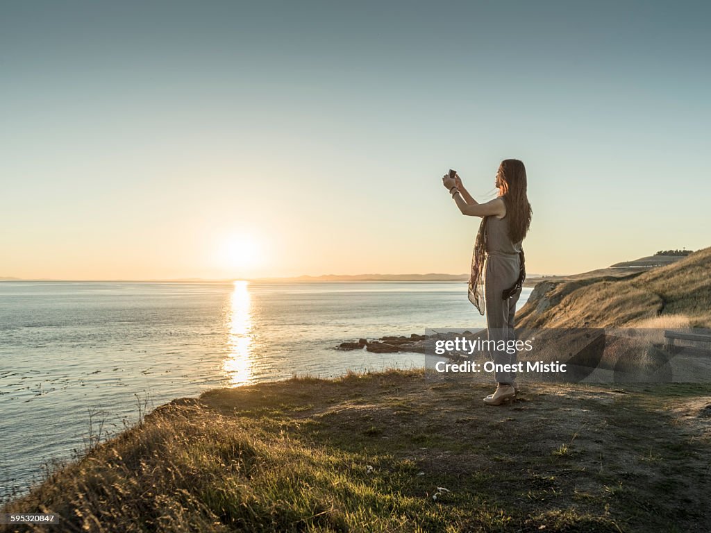 Asian beautiful woman taking  picture at cliff