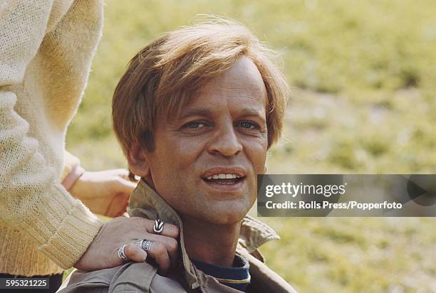 German actor Klaus Kinski pictured sitting in a grass field during production of the Italian film 'The Vatican Affair' in Italy in March 1968.
