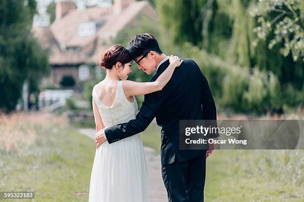 young couple walking in garden - newlywed stock pictures, royalty-free photos & images