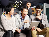 young asian business people using tablet in office