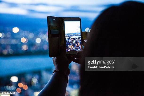 tourist taking pictures to city skyline - osaka skyline stock pictures, royalty-free photos & images