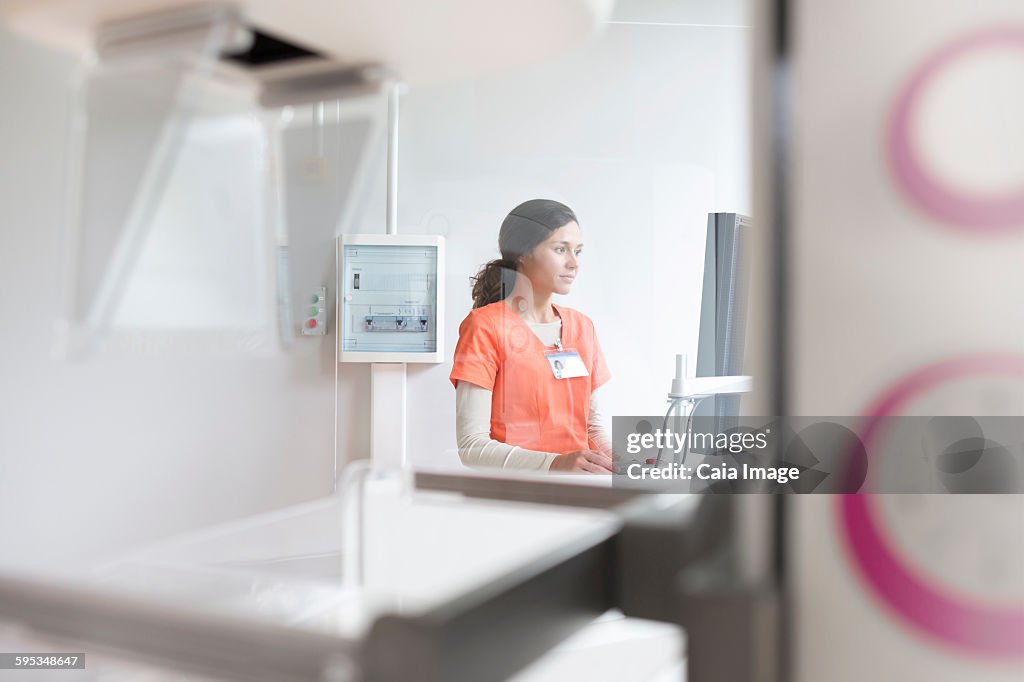 Nurse working at computer in hospital