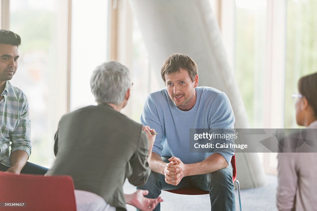 Business people talking in group meeting