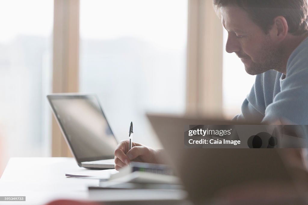 Focused businessman taking notes in meeting