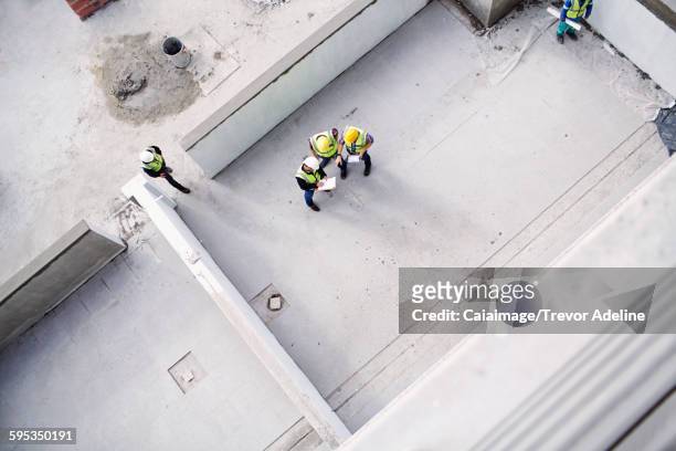 Overhead view of construction workers and engineers at construction site