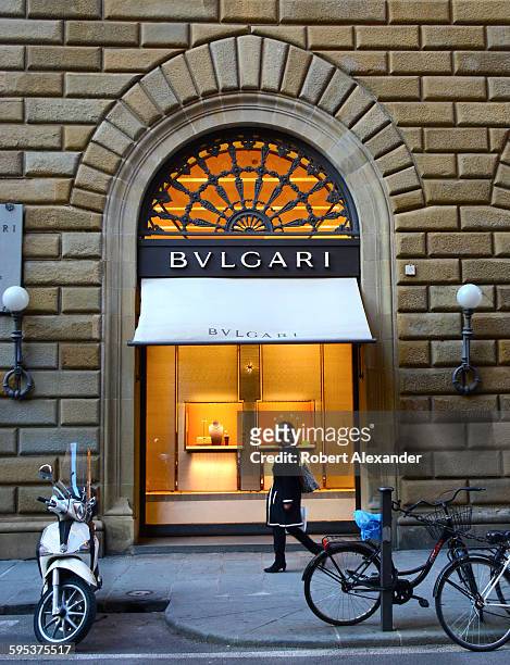 Shoppers walk past the Bulgari store on Via Tornabuoni in Florence, Italy. Bulgari is an upscale retailer of Italian jewelry, watches, accessories...