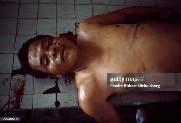 Close-up of a corpse in the city morgue, La Libertad, El Salvador, August 10, 1984. The victim had been shot in the face and showed additional signs...