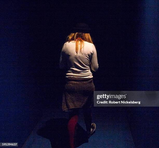 View from behind as a woman enters a video installation at the Museum of Modern Art, New York, New York, October 27, 2015.
