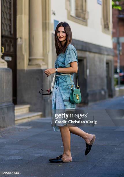 August 25: Golestaneh Mayer-Uellner wearing a green handprinted handmade linen cape dress with belt from Mica Design Berlin, black Princetown leather...