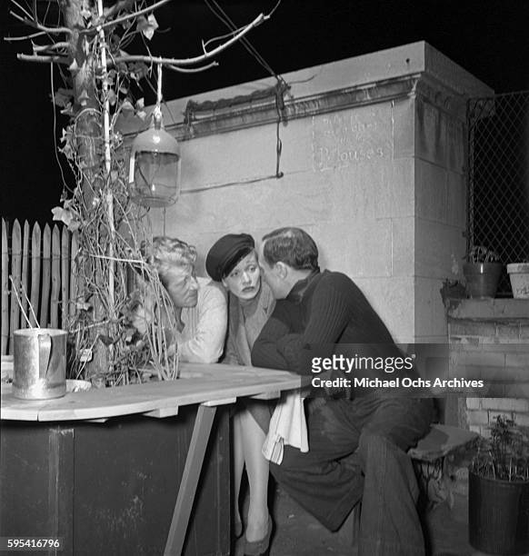 German actress Marlene Dietrich with French actor Jean Gabin and French artist Bernard Lamotte at La Vie Parisienne restaurant located at 3 East 52nd...