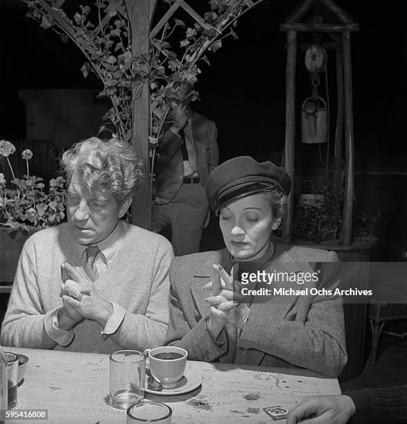 German actress Marlene Dietrich with French actor Jean Gabin play 'Here is the Church, Here is the Steeple' at La Vie Parisienne restaurant located...