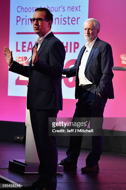 Jeremy Corbyn listens to Owen Smith sum up at the Labour Party leadership debate on August 25, 2016 in Glasgow, Scotland. Jeremy Corbyn and Owen...